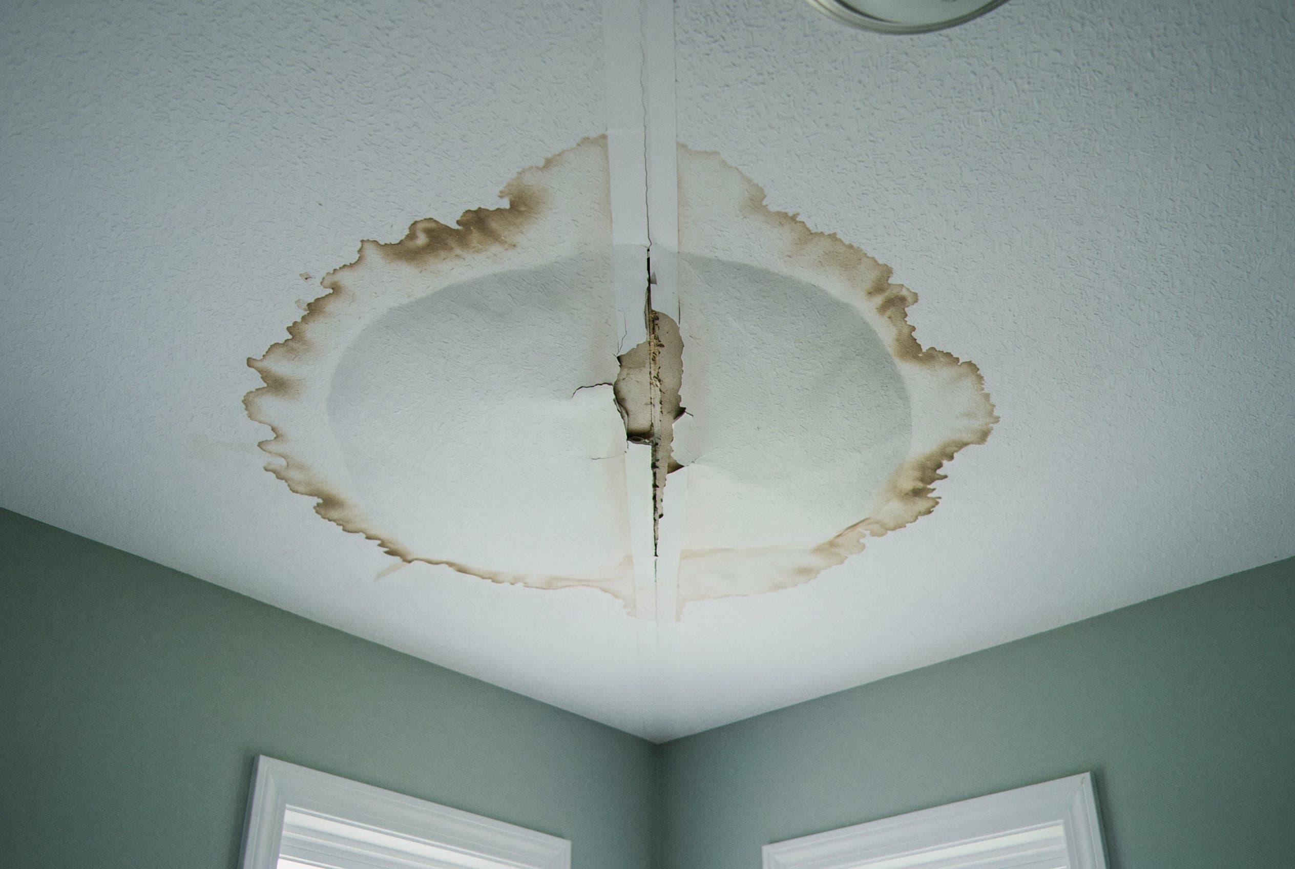 Ceiling drywall stained and damaged from water leak